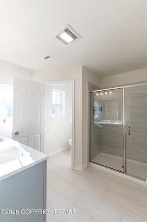 a bathroom with a tub shower and sink