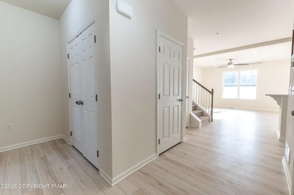 a view of a hallway with wooden floor