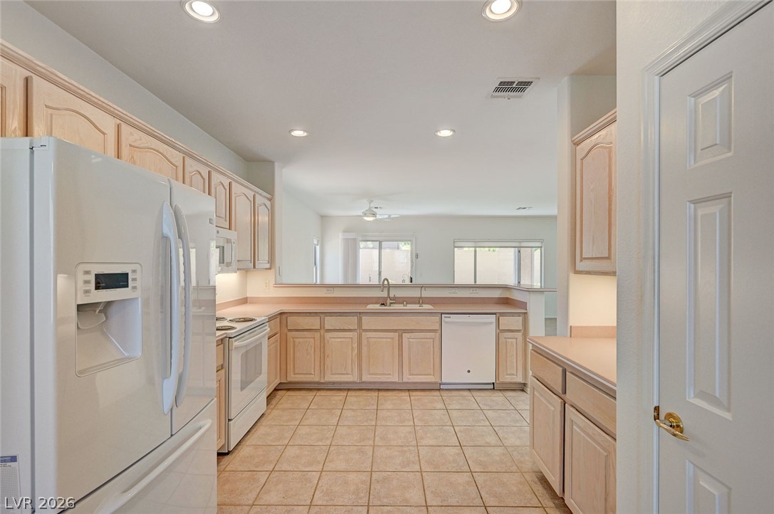 2529 Springville Way Henderson, NV 89052 - Photo 20 of 70 Ample cabinetry and tile flooring define this functional kitchen layout.