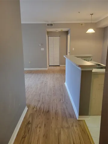 a kitchen with a wooden floor and a sink