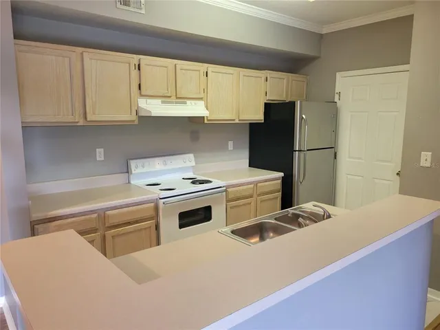a kitchen with a sink stove and cabinets