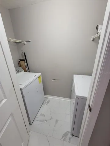 a view of an empty room with a fireplace and a window