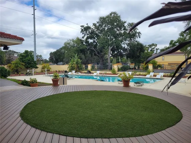 a swimming pool with outdoor seating and yard