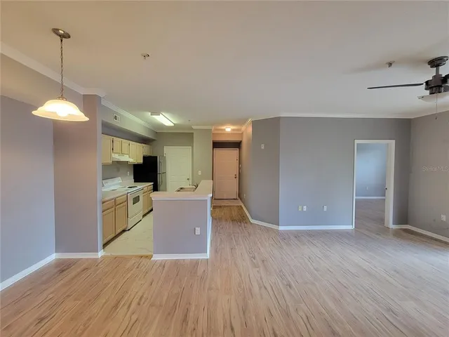a view of a kitchen with a sink wooden floor and a refrigerator
