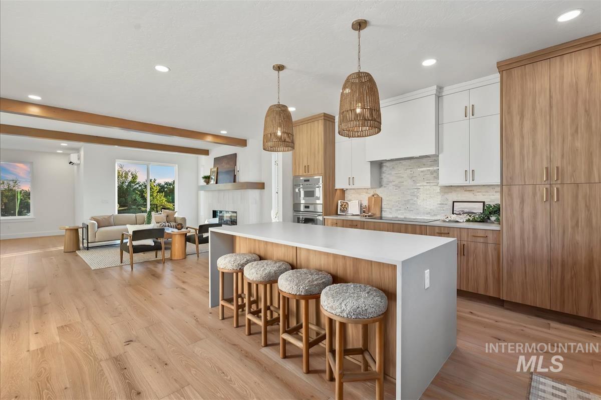 3219 West Moore Street Boise, ID 83702 - Photo 17 of 36 Expansive open-concept living area featuring wide-plank wood-finish flooring