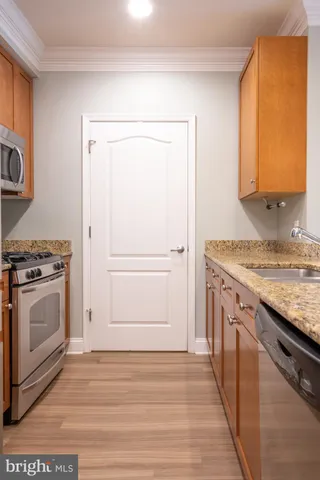 a kitchen with a stove cabinets and a wooden floor