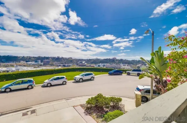 a view of a lake with couches and city view