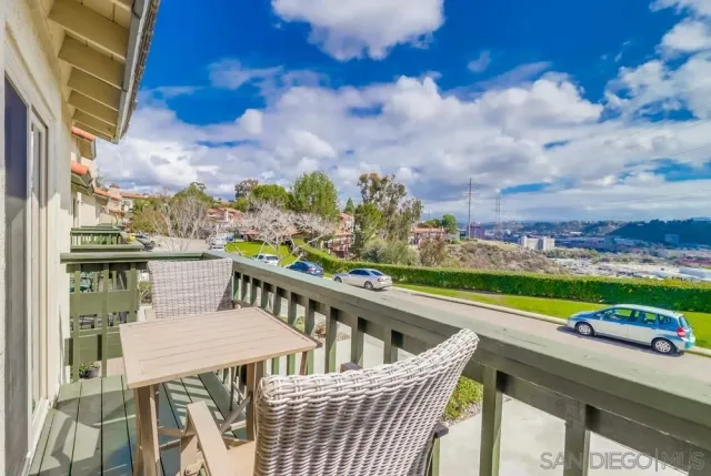 a view of a chairs and table on the balcony