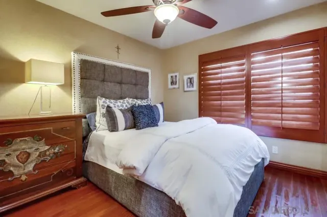 a bedroom with a large bed and a window