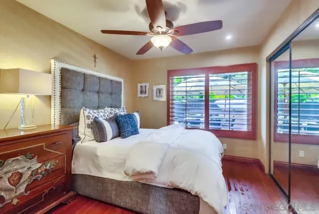 a bedroom with a large bed and a chandelier