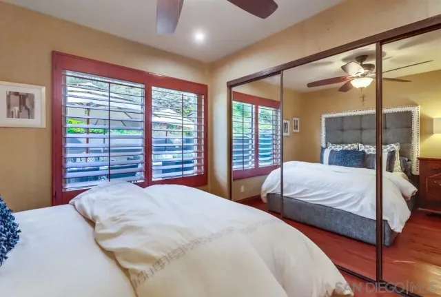 a bedroom with a large bed and a large window