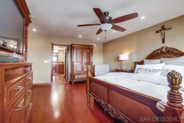 a bed room with a bed and a ceiling fan