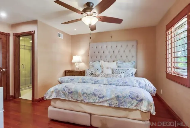 a bedroom with a large bed and a chandelier