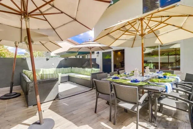 a view of a patio with a table and chairs and potted plants