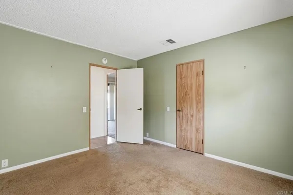 a view of a kitchen with a refrigerator a ceiling fan and wooden floor