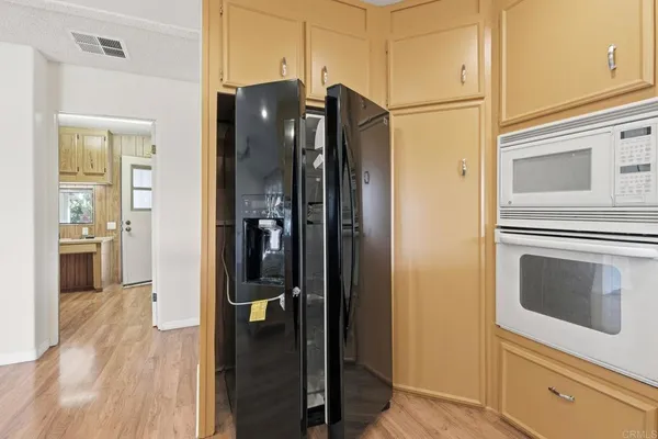 a kitchen with stainless steel appliances granite countertop a stove and a microwave