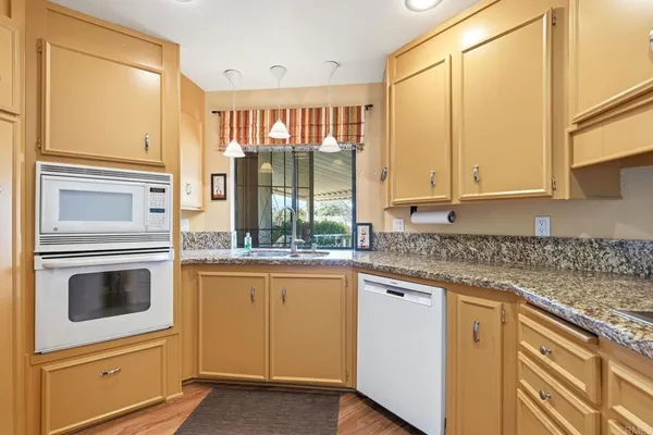 a view of an empty room with kitchen