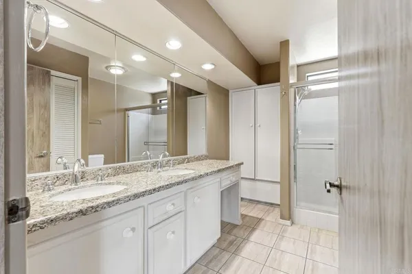 a view of a hallway with furniture and floor to ceiling window