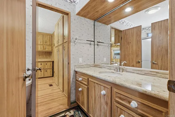 a bathroom with a shower a toilet and a sink
