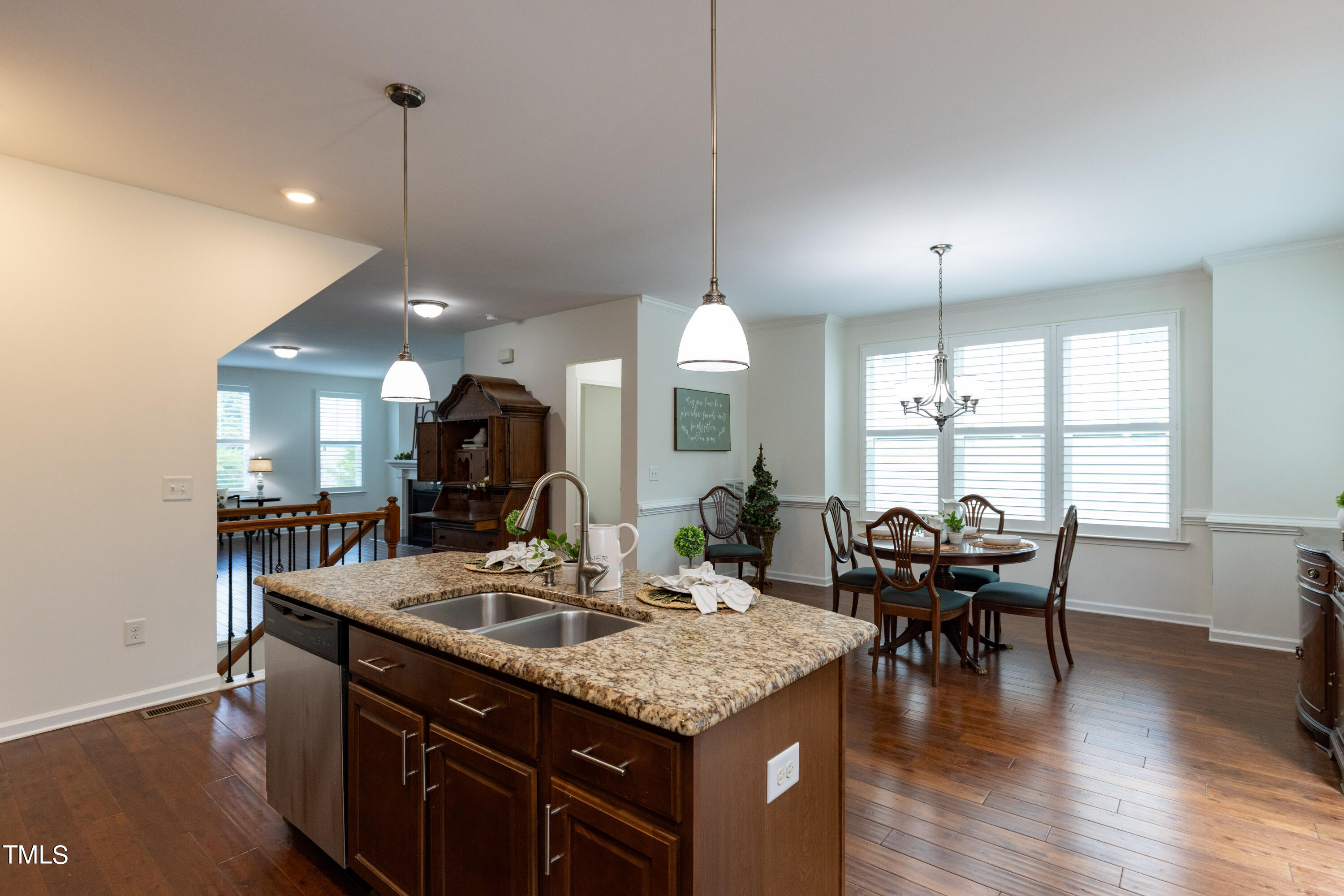 711 Edgewater Ridge Court Apex, NC 27523 - Photo 11 of 29 a kitchen with center island table and chairs