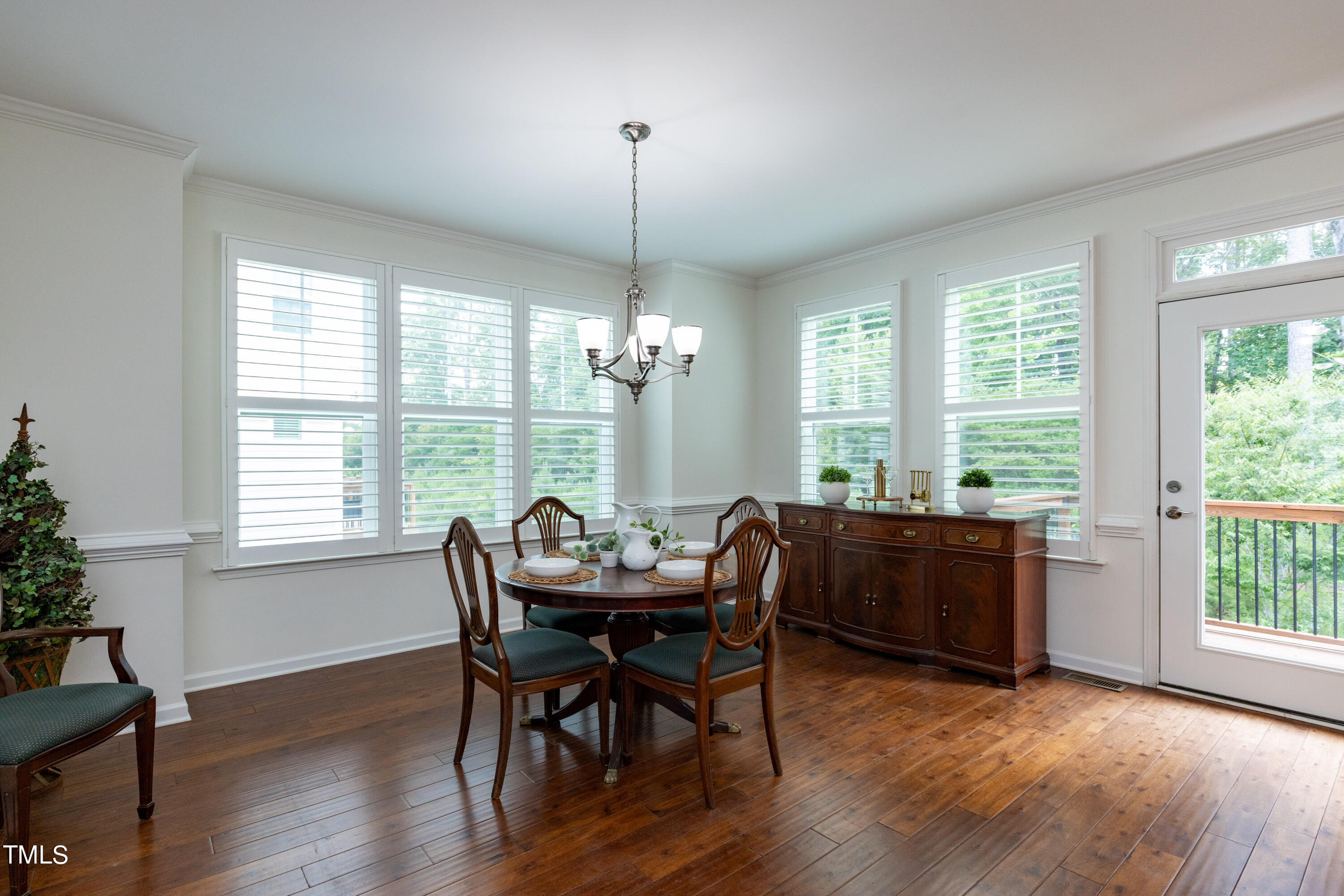 711 Edgewater Ridge Court Apex, NC 27523 - Photo 13 of 29 a view of a dining room with furniture window and wooden floor