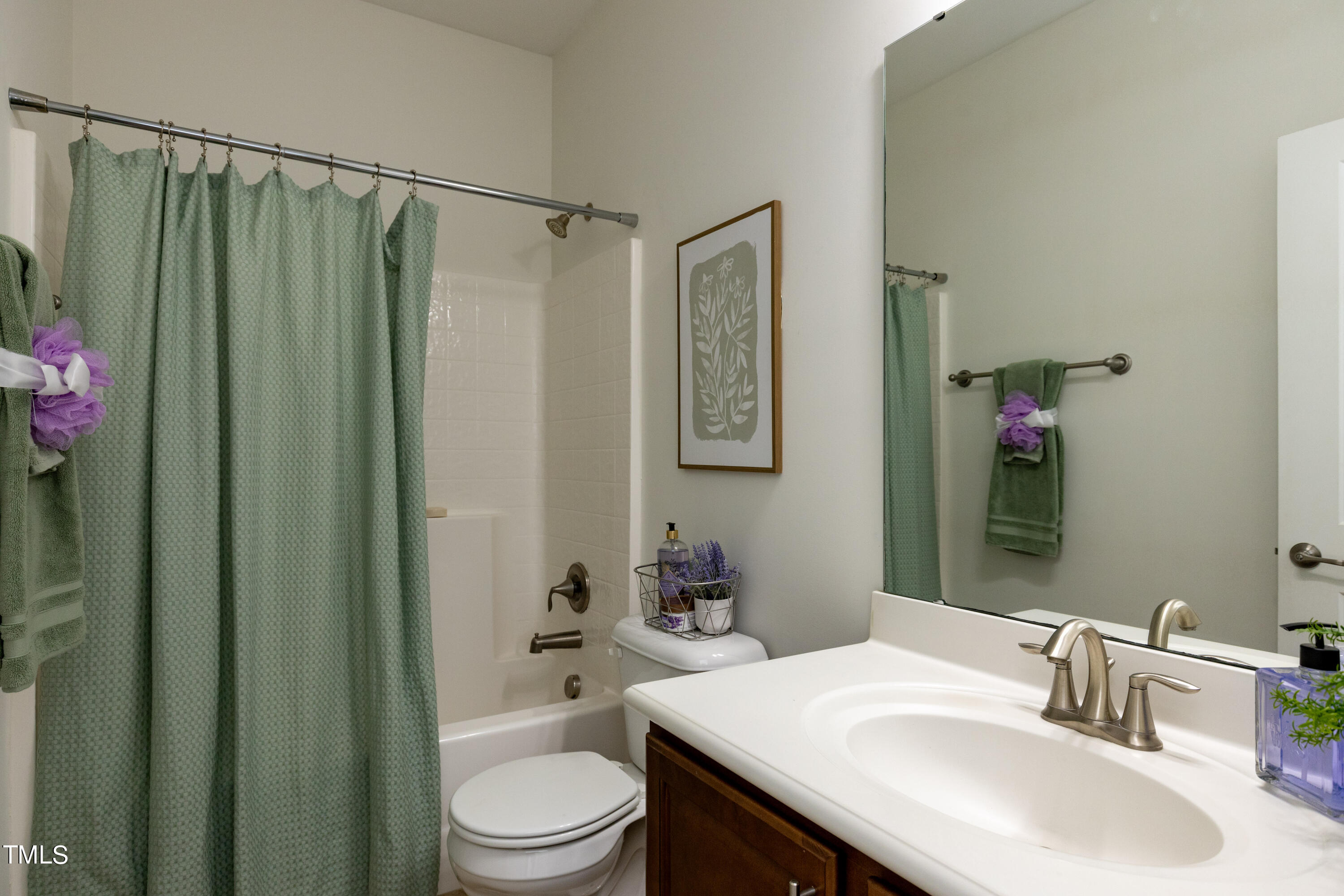 711 Edgewater Ridge Court Apex, NC 27523 - Photo 20 of 29 a bathroom with a sink a toilet and shower