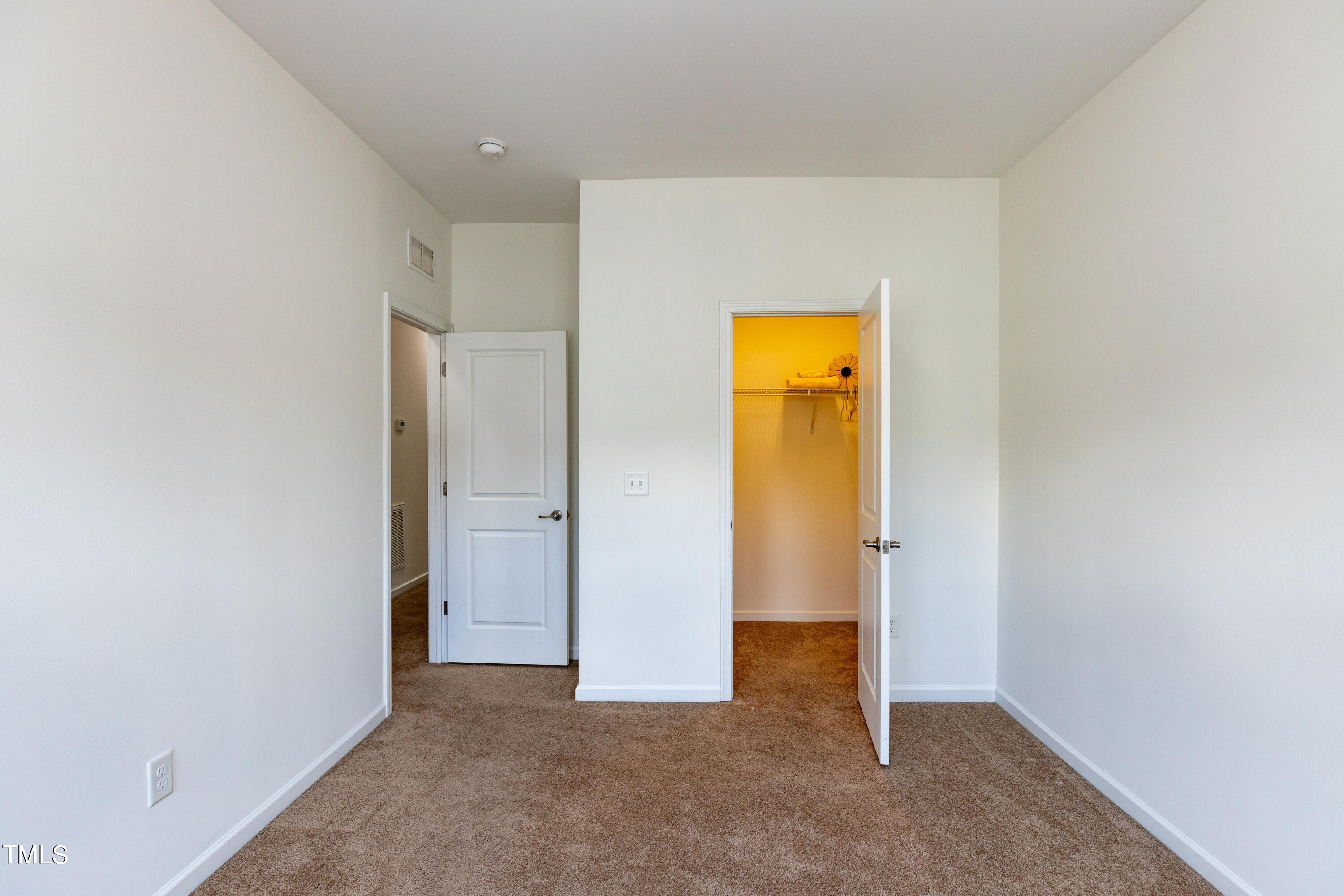711 Edgewater Ridge Court Apex, NC 27523 - Photo 22 of 29 an empty room with a hallway and a closet
