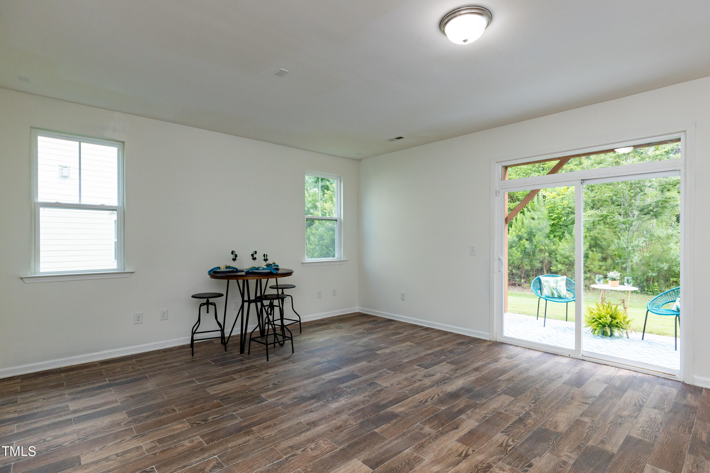 711 Edgewater Ridge Court Apex, NC 27523 - Photo 24 of 29 a view of a room with wooden floor and a window