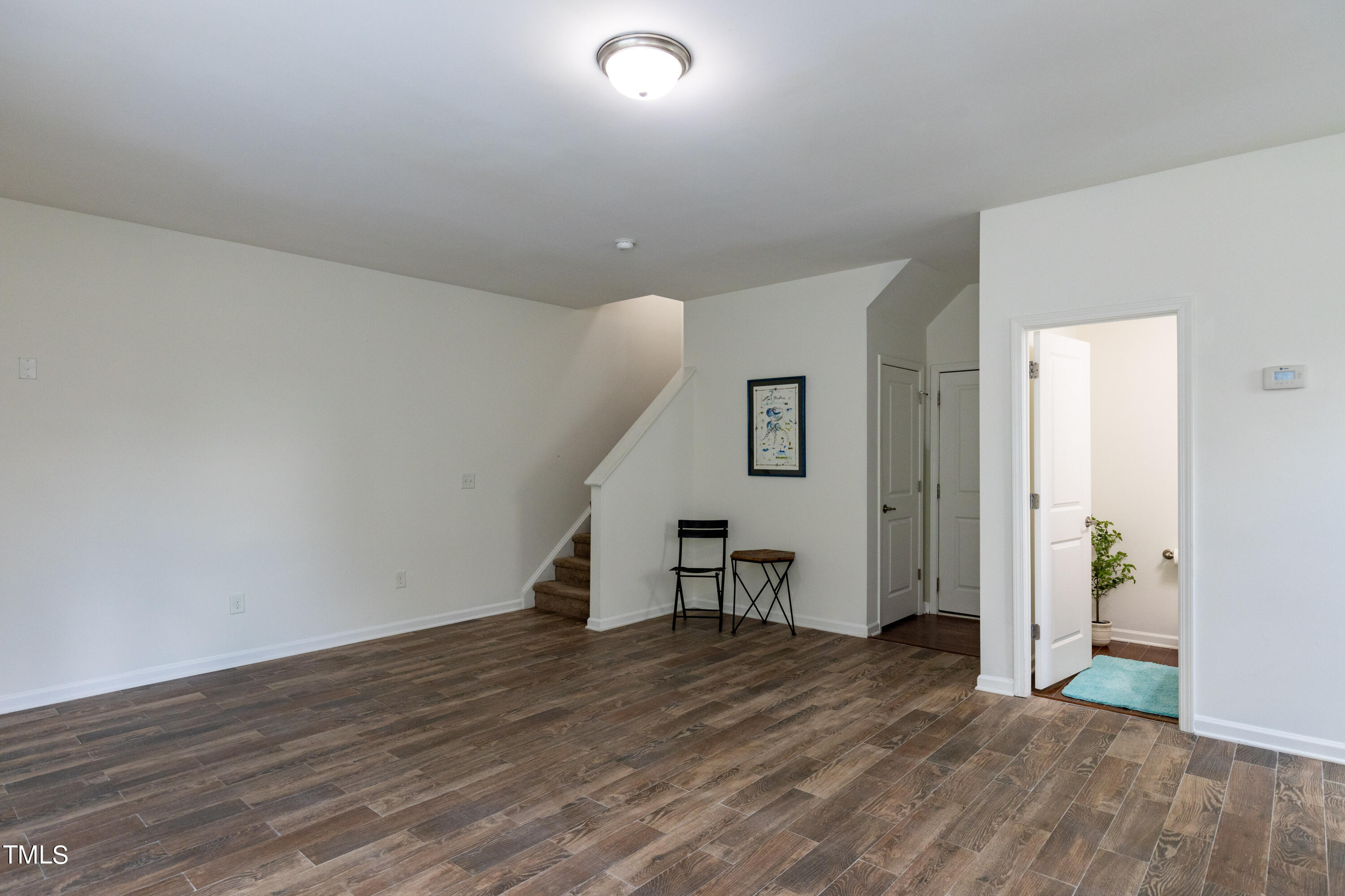 711 Edgewater Ridge Court Apex, NC 27523 - Photo 25 of 29 a view of empty room with wooden floor