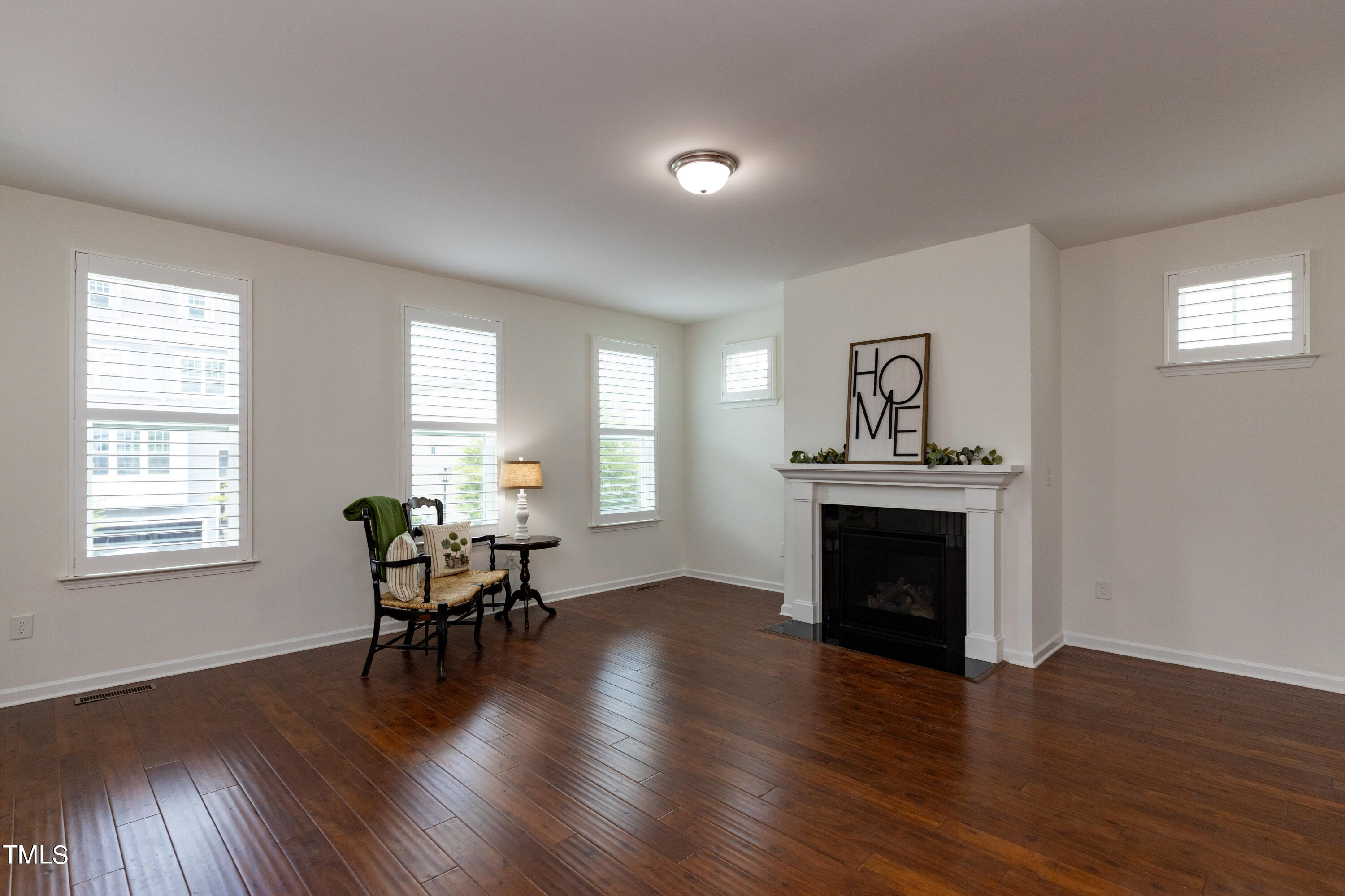 711 Edgewater Ridge Court Apex, NC 27523 - Photo 5 of 29 a living room with furniture and a fireplace