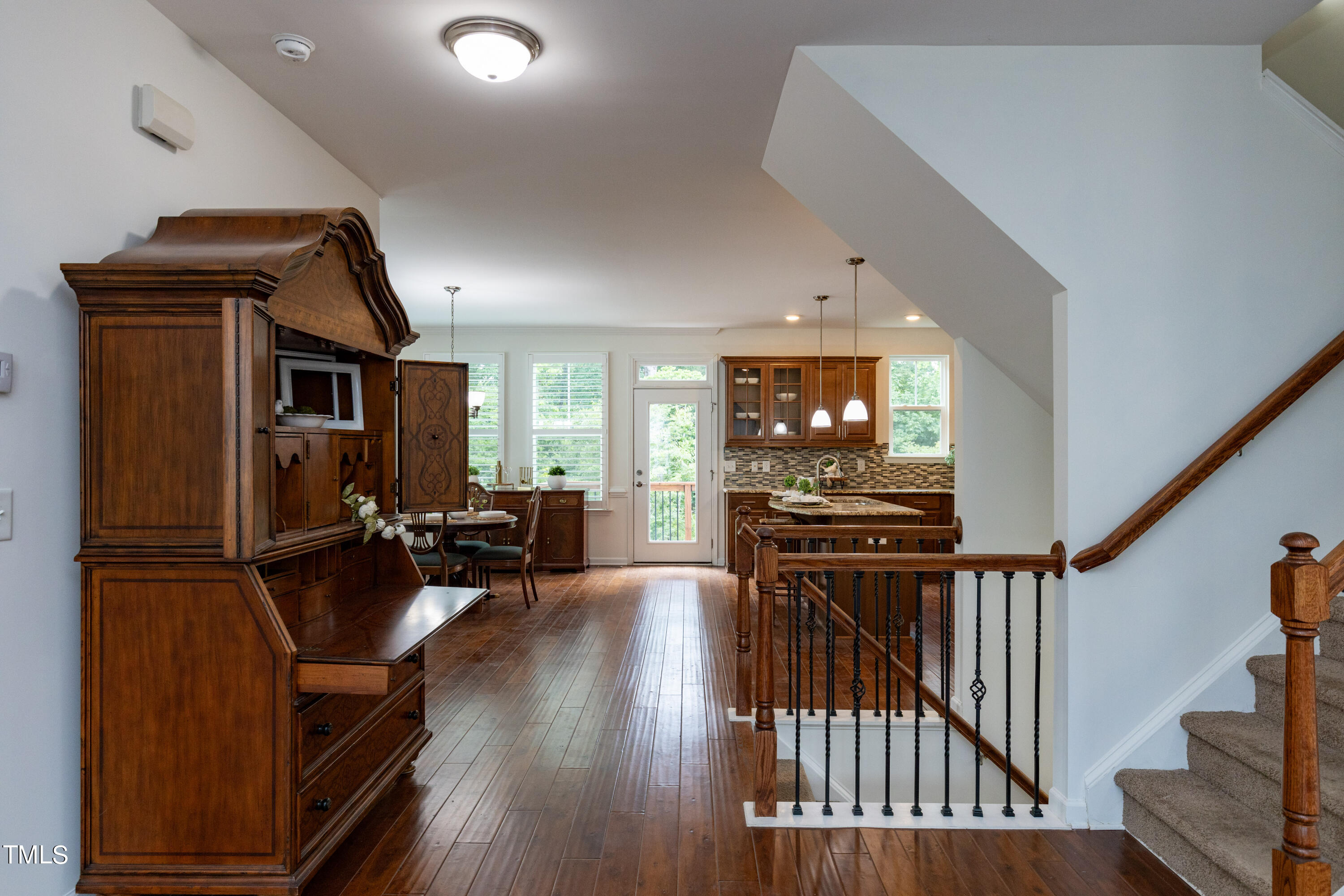 711 Edgewater Ridge Court Apex, NC 27523 - Photo 8 of 29 a view of living room kitchen with furniture and wooden floor