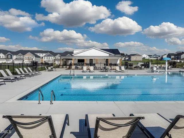 a view of a swimming pool and outdoor seating
