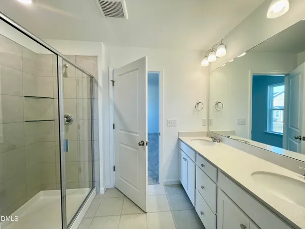 a spacious bathroom with a shower and a sink