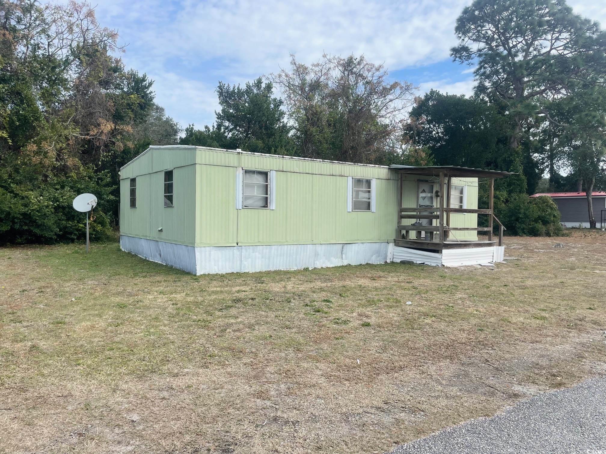 4125 Little River Road Myrtle Beach, SC 29577 - Photo 3 of 3 Manufactured / mobile home with a front lawn and covered porch