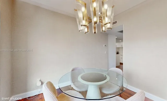 a view of a dining room with furniture and chandelier