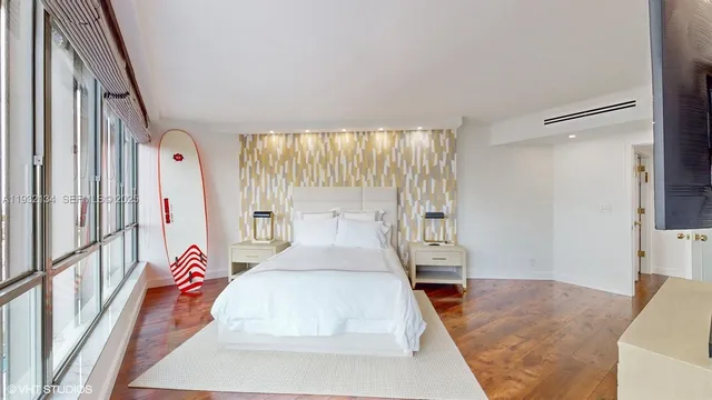 a bedroom with a bed and a large window