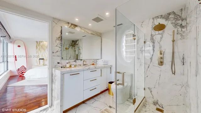 a bathroom with a sink mirror and shower