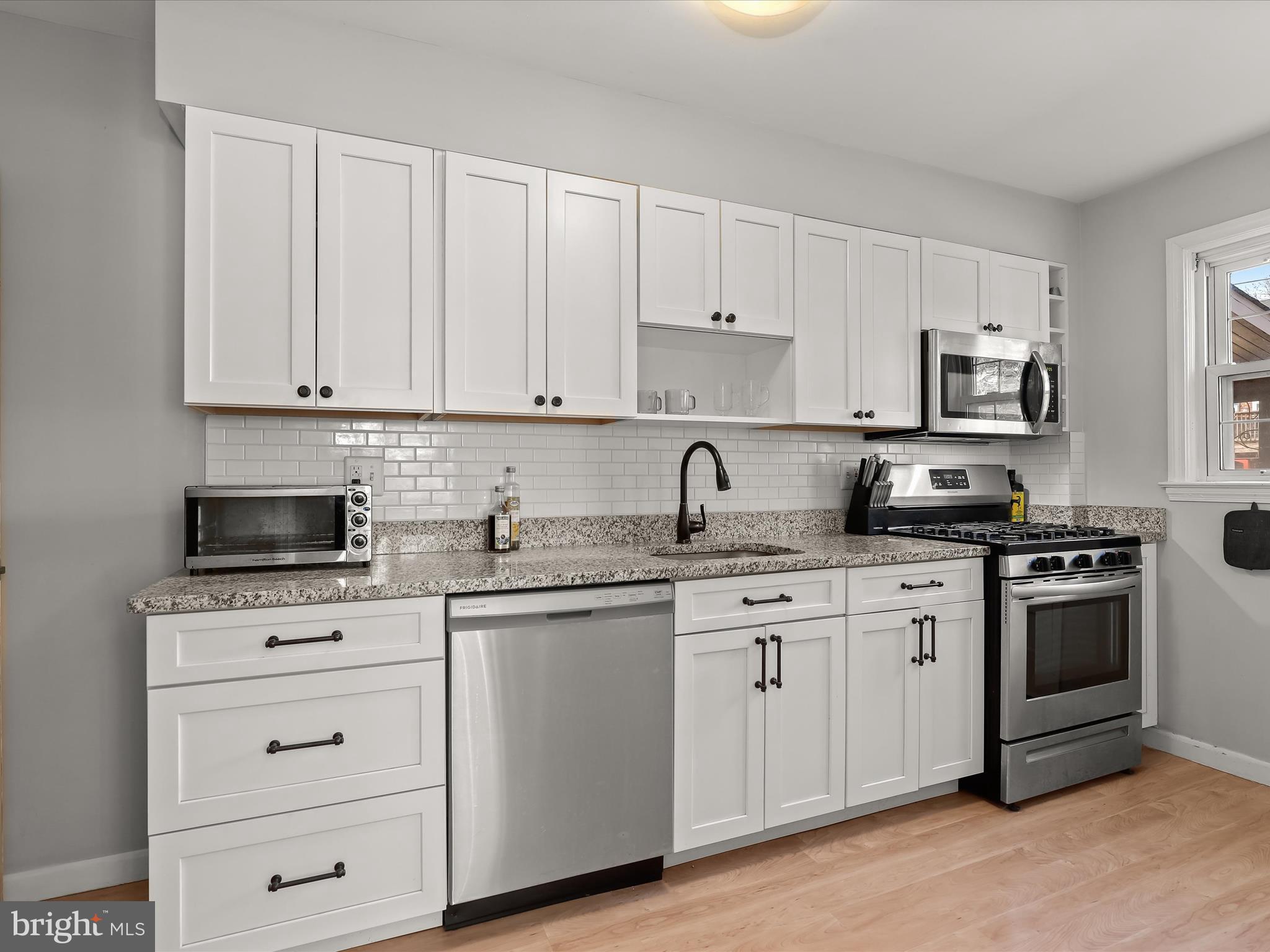 1632 Aberdeen Road Towson, MD 21286 - Photo 13 of 35 a kitchen with granite countertop white cabinets sink and stainless steel appliances