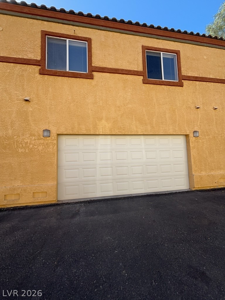 4915 East Russell Road, Unit 145 Las Vegas, NV 89120 - Photo 13 of 13 Garage featuring asphalt driveway