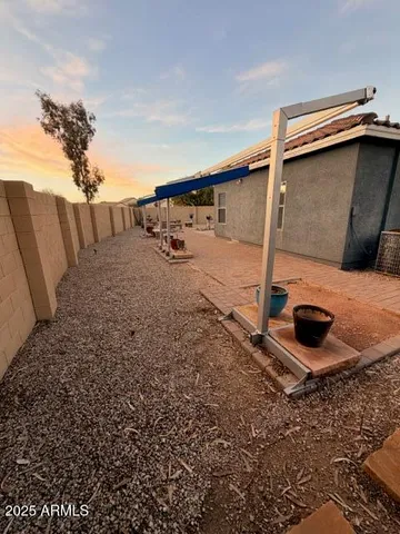 a backyard of house with wooden fence
