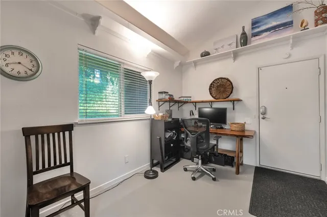 a view of a hallway with wooden floor and chandelier