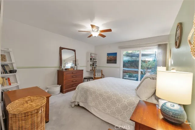 a bedroom with a bed and a lamp on dresser