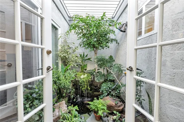 a view of bathroom with a granite countertop sink a light fixture and a mirror