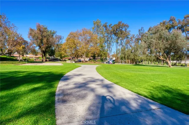 a view of a swimming pool with a patio and couches chairs