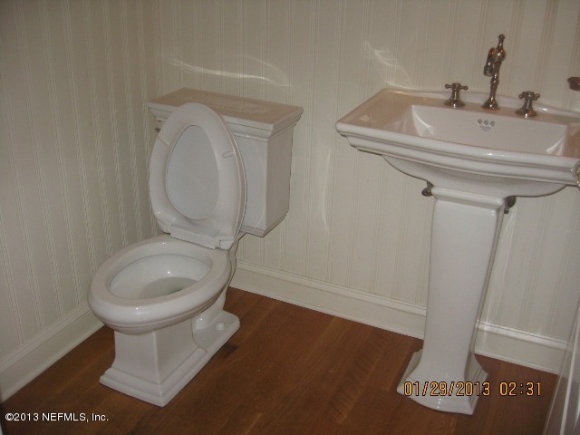 11860 Mandarin Road Jacksonville, FL 32223 - Photo 14 of 43 a bathroom with a toilet sink and mirror