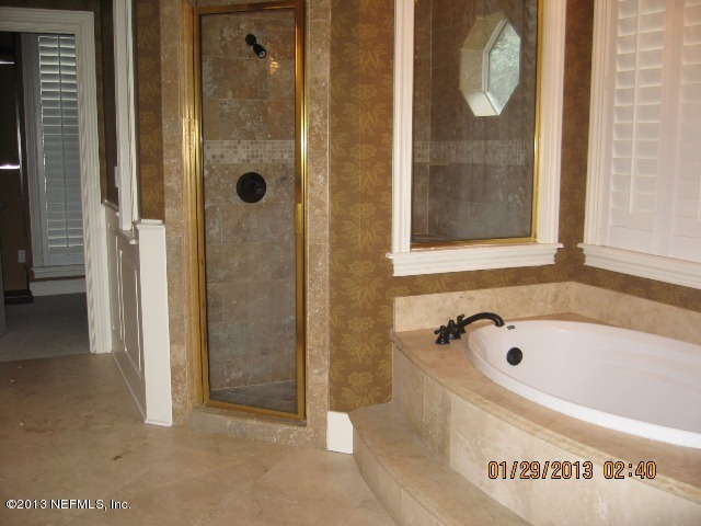 11860 Mandarin Road Jacksonville, FL 32223 - Photo 17 of 43 a bathroom with a bathtub and shower