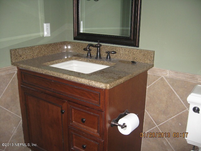 11860 Mandarin Road Jacksonville, FL 32223 - Photo 36 of 43 a bathroom with a granite countertop sink and a mirror