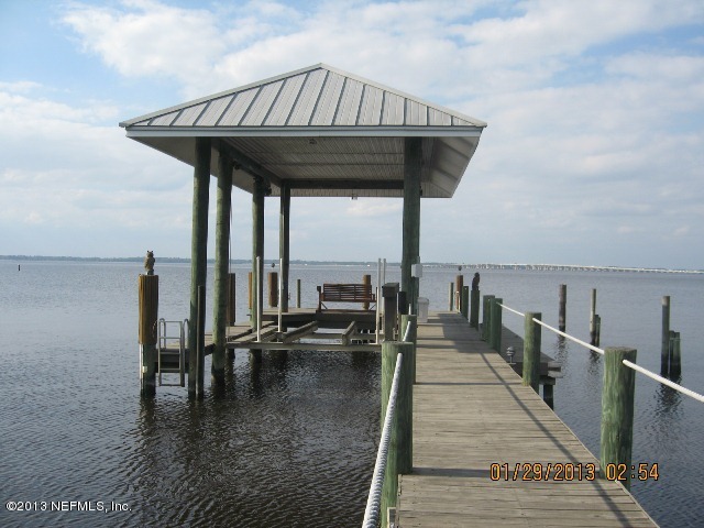 11860 Mandarin Road Jacksonville, FL 32223 - Photo 38 of 43 a balcony with wooden floor table and chairs