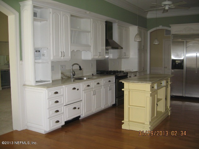 11860 Mandarin Road Jacksonville, FL 32223 - Photo 9 of 43 a kitchen with cabinets appliances and a counter top