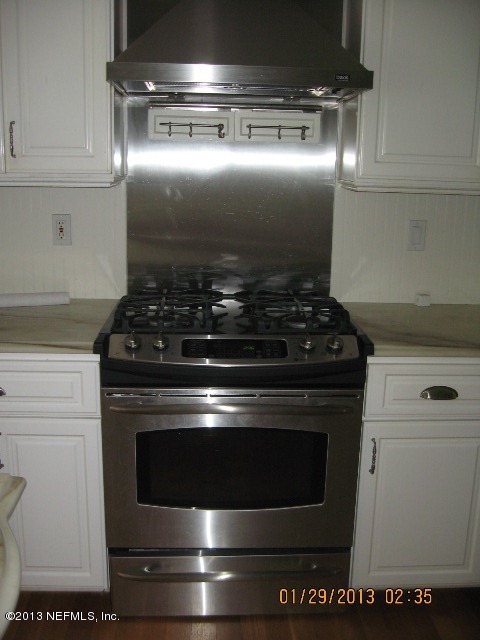 11860 Mandarin Road Jacksonville, FL 32223 - Photo 10 of 43 a stove top oven sitting inside of a kitchen